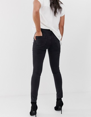 ASOS Maternity DESIGN Maternity high rise ridley 'skinny' jeans in washed black with under the bump waistband