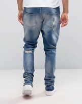 Thumbnail for your product : ASOS Drop Crotch Stacked Jeans With Rips And Bleaching In Mid Blue