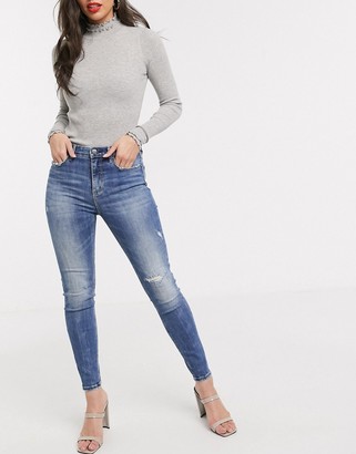 Stradivarius super high waist skinny jeans in with rip in medium blue -  ShopStyle