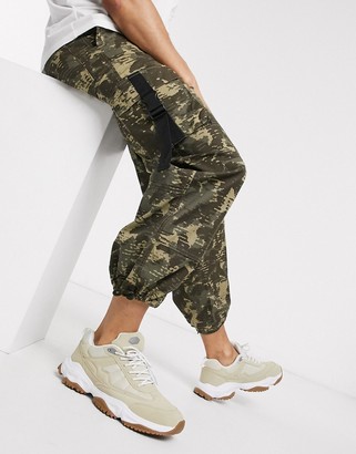 ASOS DESIGN wide leg cargo trousers in camo print