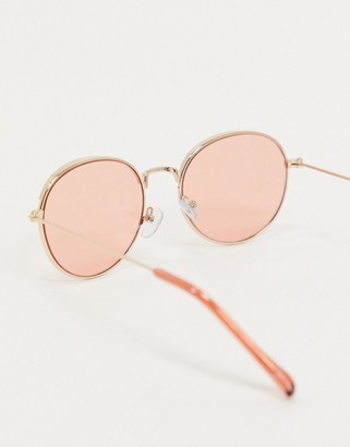 ASOS DESIGN round sunglasses in gold with light pink lens