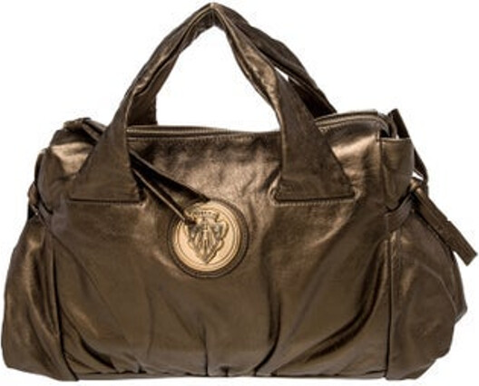 Gucci Top Handle Bag Gold & Metallic Leather Hysteria Accent Gold-Tone Hardware Flat Handles Leather & Pleated Accents Logo Jacquard Lining & Three Interior Pockets Zip Closure at Top Unfortunately, due to restrictions, this item may not be eligible for shipping in all areas.