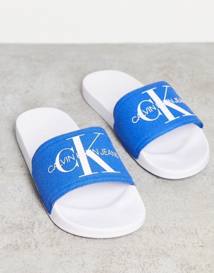 Calvin Klein Viggo sliders in blue - ShopStyle Flip Flop Sandals