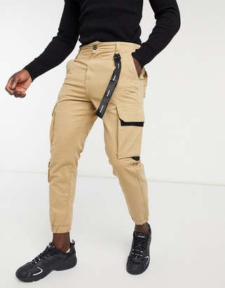 Bershka cargo pants with black trim detail in beige - ShopStyle