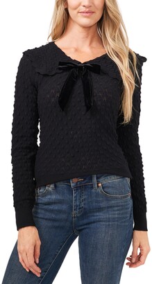 black sweater with bow on shoulder