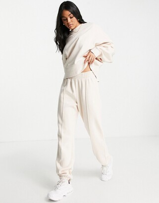 Nike mini swoosh oversized joggers in pearl white - ShopStyle Plus Size  Trousers