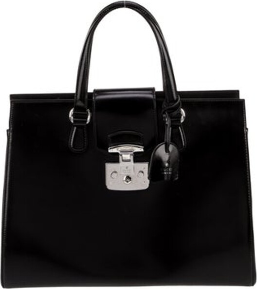 Gucci Top Handle Bag Black Leather Lady Lock Accent Silver-Tone Hardware Flat Handles & Single Adjustable Shoulder Strap Suede Lining & Single Interior Pocket Push-Lock Closure at Front Protective Feet at Base Includes Keys & Clochette Unfortunately, due to restrictions, this item may not be eligible for shipping in all areas.