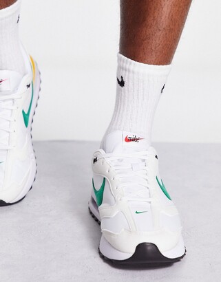 nike outburst trainers in white and green