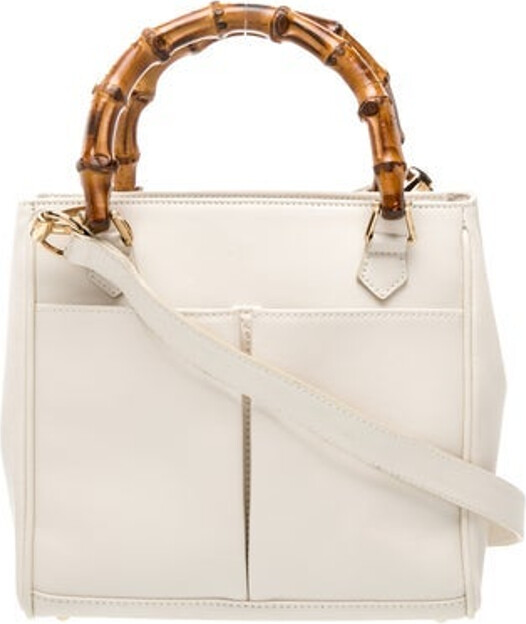 Gucci Top Handle Bag Vintage Neutrals Leather Bamboo Accent Gold-Tone Hardware Bamboo Trim Single Shoulder Strap Dual Exterior Pockets Leather Lining & Single Interior Pocket Fold-In Flap Closure at Top Protective Feet at Base Includes Dust Bag Unfortunately due to restrictions this item may not be eligible for shipping in all areas.