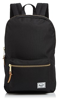 black leather backpack with gold zippers