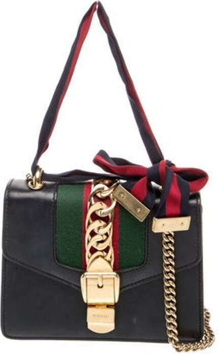 Gucci Shoulder Bag Black Leather Colorblock Pattern Web Accent Gold-Tone Hardware Acrylic Trim Chain-Link Shoulder Strap Grosgrain Trim Suede Lining & Single Interior Pocket Flap Closure at Front Unfortunately due to restrictions this item may not be eligible for shipping in all areas.