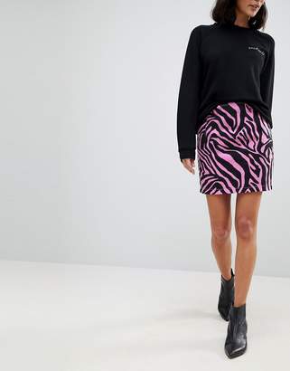 ASOS DESIGN Denim Mini Skirt in Pink Zebra Print