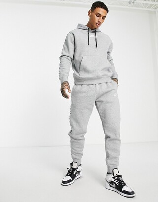 Nike Repeat logo taped fleece tracksuit set in grey - ShopStyle Trousers