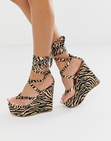 Thumbnail for your product : ASOS DESIGN DESIGN Tribute thong tie leg wedges in tiger