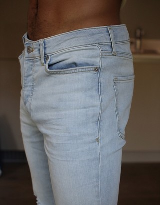 Topman skinny jeans with extreme rips in light wash blue