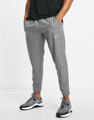 Nike Running Challenger Dri-FIT woven joggers in grey - ShopStyle Trousers