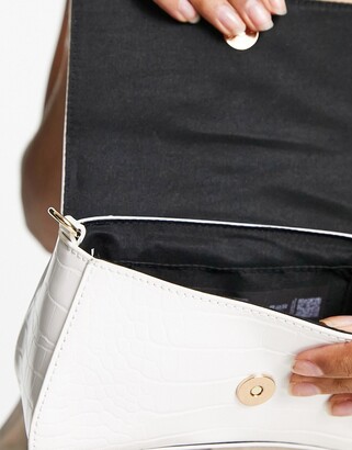 ASOS DESIGN curved crossbody bag with triangle hardware in white - ShopStyle