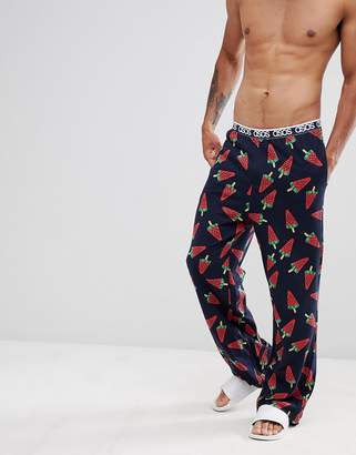 ASOS Design DESIGN straight pyjama bottoms in melon print in organic cotton-Navy