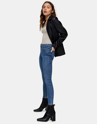 Topshop Jamie jeans with abraded hem detailing in mid blue