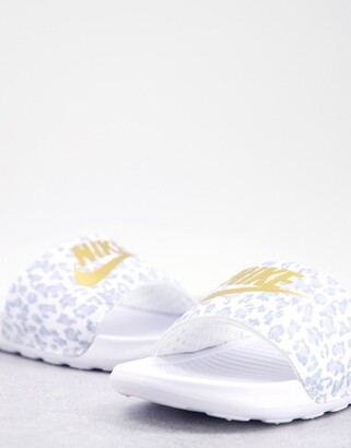Nike Victori slides in white leopard print and gold swoosh - ShopStyle