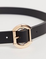 Thumbnail for your product : ASOS DESIGN skinny belt in black faux leather with gold circle buckle