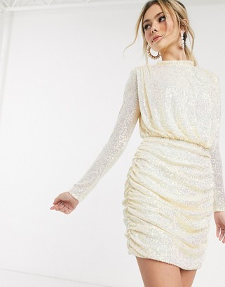 In The Style x Fashion Influx sequin ruched high neck mini dress with open back in cream