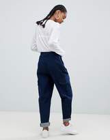 Thumbnail for your product : ASOS DESIGN tapered jeans with curved seam in indigo wash with utility pockets