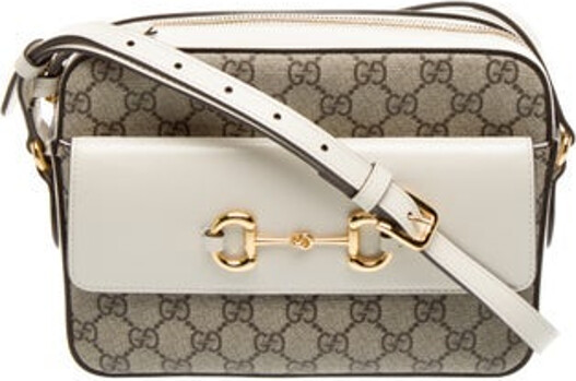 Gucci Crossbody Bag By Alessandro Michele Neutrals GG Supreme & 1955 Horsebit Accent Gold-Tone Hardware Leather Trim Single Adjustable Shoulder Strap Leather Trim Embellishment & Single Exterior Pocket Suede Lining & Single Interior Pocket Zip Closure at Top Includes Dust Bag