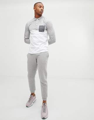 ASOS DESIGN long sleeve polo shirt with contrast yoke and pocket in interest fabric in white