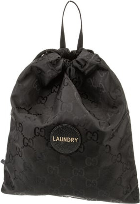 Gucci Backpack Black Nylon GG Nylon Leather Trim Flat Handle Leather Trim Embellishment Nylon Lining Drawstring Closure at Top Includes Dust Bag