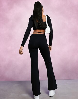 ASOS DESIGN low rise flare pants with strap detail and ruched waist in black  - ShopStyle Wide-Leg Trousers