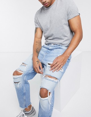Bershka loose fit jeans with rips in blue - ShopStyle