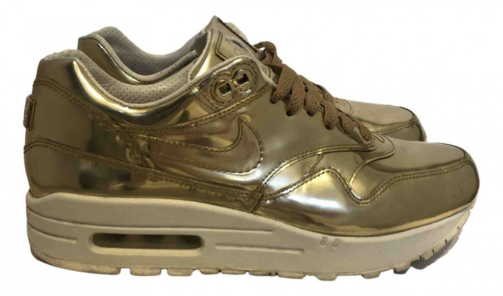 gold nike trainers