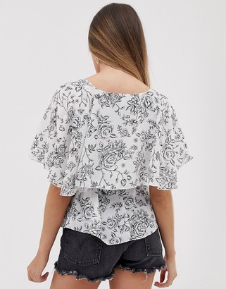 ASOS DESIGN DESIGN short sleeve sheer wrap top with cape detail in floral print