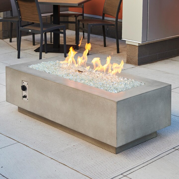 The Outdoor GreatRoom Company Cove 54 Inch Rectangular GFRC Propane Fire Pit Table w/ Electronic Ignition in Natural Gray by