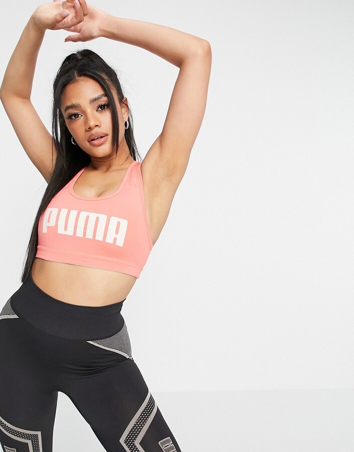 Puma Training mid support text logo 4 Keeps sports bra in pink - ShopStyle