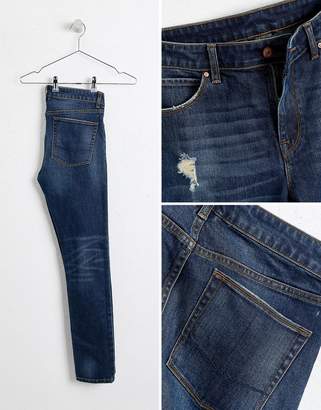 ASOS DESIGN super skinny jeans in dark wash blue with abrasions