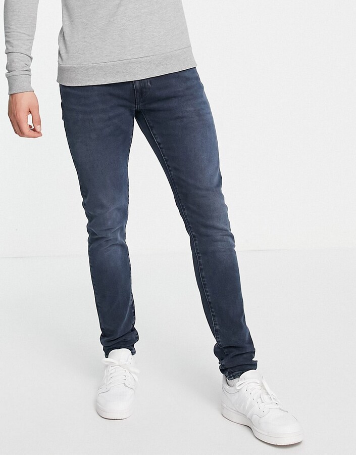 Levi's skinny tapered fit jeans in dark navy overdye - ShopStyle