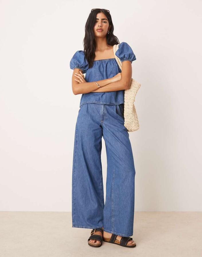 ASOS DESIGN wide leg jeans with pleated waist in mid blue part of