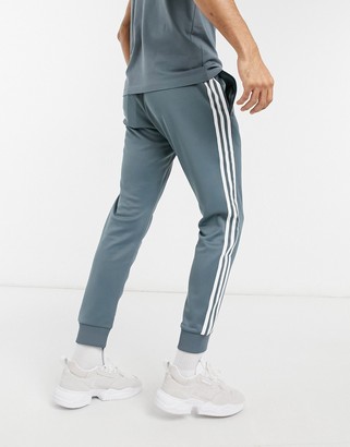 adidas Superstar track sweatpants in blue oxide - ShopStyle Activewear Pants