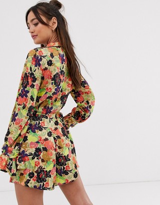 ASOS DESIGN DESIGN wrap romper with buckle and ruffle cuffs in jacquard floral print