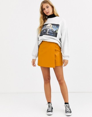 ASOS DESIGN wrap A line leather look mini skirt with snap buttons
