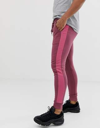 ASOS Design DESIGN skinny joggers with side stripe in purple