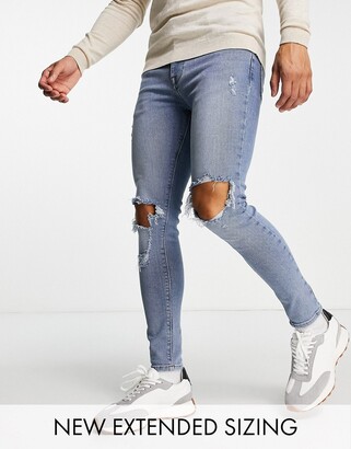 ASOS DESIGN spray on jeans in power stretch in mid wash with knee rips and  abrasions - ShopStyle