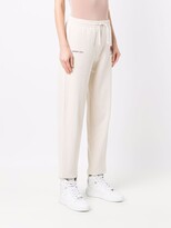 Thumbnail for your product : Axel Arigato Keith Haring-embroidered track pants