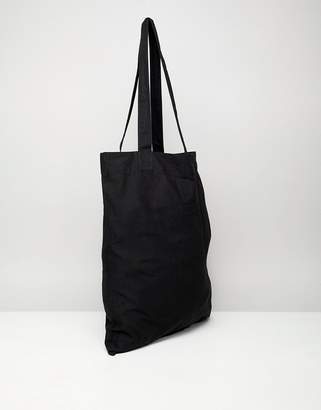 ASOS Design DESIGN organic tote bag in black with subliminal print