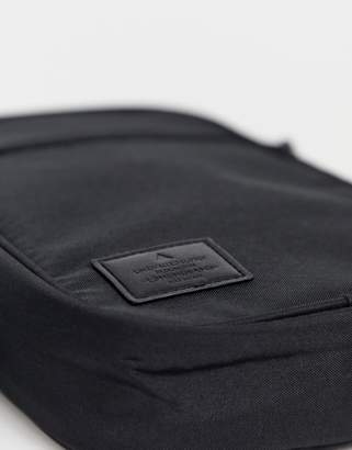 ASOS DESIGN cross body flight bag in black with branded patch