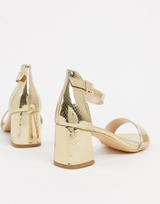 Glamorous mid heeled sandals in lizard embossed gold