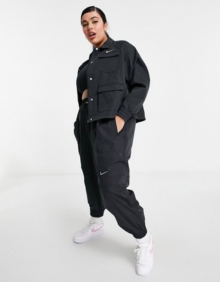 nike swoosh plus woven jacket in black with utility pockets