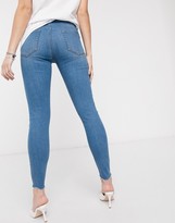 Thumbnail for your product : ASOS DESIGN Maternity high rise ridley 'skinny' jeans in lightwash blue with knee rips and raw hem with under bump